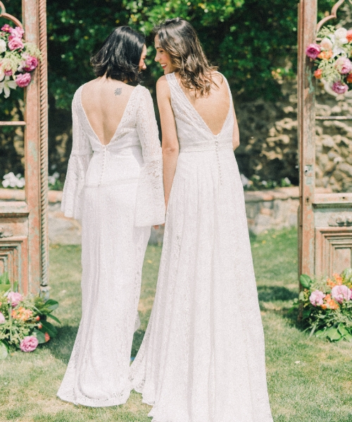 brides laughing under arch